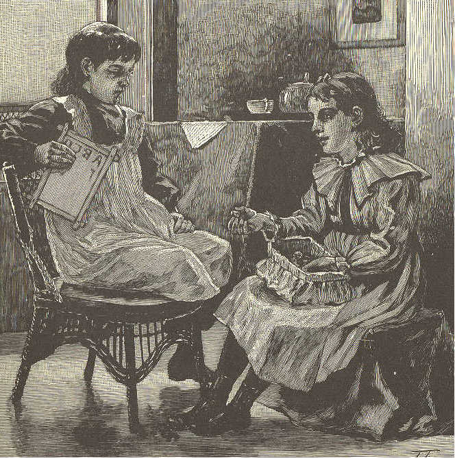 Two girls seated, talking.