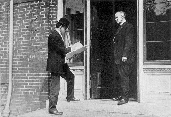 TAKING THE CENSUS IN A CITY. Enumerator at a doorway,
entering in his portfolio the details of a household.