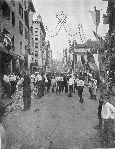 FESTA IN THE ITALIAN QUARTER. Boys in Little Italy, New
York, preparing for one of the many characteristic holidays. (Brown
Bros.)