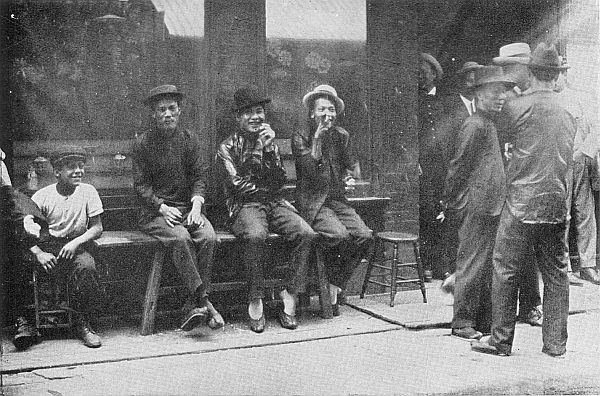 THE FIGHTING MEN OF THE TONGS. The younger combatants of
the Five Brothers outside the impregnably guarded headquarters in
Chinatown, New York.