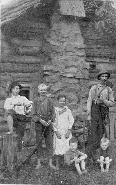 KENTUCKY MOUNTAINEER FAMILY. In the heart of the feud
district, where the rifle is never out of reach. (Courtesy of the
Spirit of Missions.)