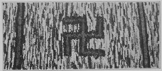 "HIT-OR-MISS" RUG WITH SWASTIKA CENTRE