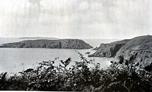 BRECQHOU FROM THE SOUTH. "I looked across at BRECQHOU as I came in sight of the Western Waters." This shows BRECQHOU from the south. The dark gash near the head is THE PIRATES' CAVE. The island behind BRECQHOU is HERM. The end of JETHOU just shows on the left. GUERNSEY lies beyond them.