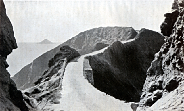 THE COUPÉE. Leading from SARK to LITTLE SARK. At the time of the story, the path was much narrower than now, there were no supporting walls, and it was continually breaking away. The pinnacles of the buttresses were also much higher. The Island to the left is LE TAS or L'ETAC.