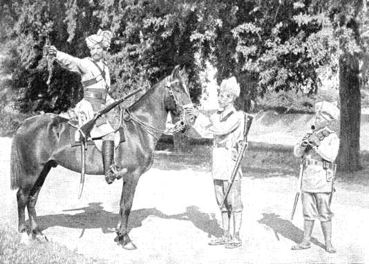 A Scout of the Guides' Cavalry warning his Infantry Comrades. The small man on the right is a Gurkha A Scout of the Guides' Cavalry warning his Infantry Comrades. The small man on the right is a Gurkha
