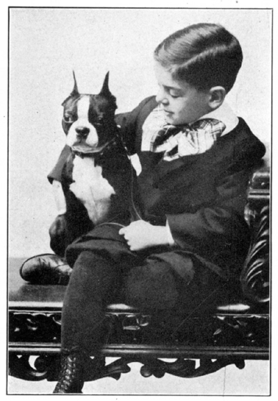 A young boy cuddles a dog