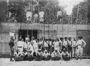 GROUP OF WORKERS ON CACAO ESTATE.
Some are standing on the Drying Platform, which is the roof of the Fermentary.