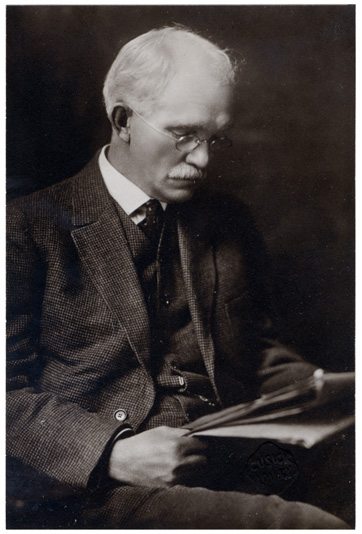 A photographic portrait of a seated man