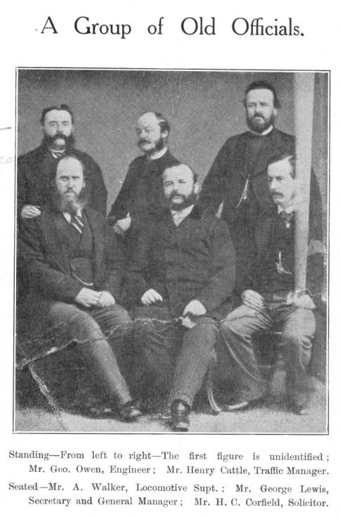 A Group of Old Officials.  Standing—From left to
right—The first figure is unidentified; Mr. Geo. Owen, Engineer; Mr.
Henry Cattle, Traffic Manager.  Seated—Mr. A. Walker, Locomotive
Supt.; Mr. George Lewis, Secretary and General Manager; Mr. H. C. Corfield,
Solicitor