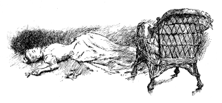 A young woman lies on the ground next to a wicker chair.