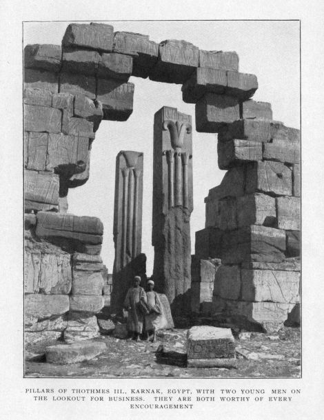 PILLARS OF THOTHMES III., KARNAK, EGYPT, WITH TWO YOUNG MEN ON THE LOOKOUT FOR BUSINESS.  THEY ARE BOTH WORTHY OF EVERY ENCOURAGEMENT