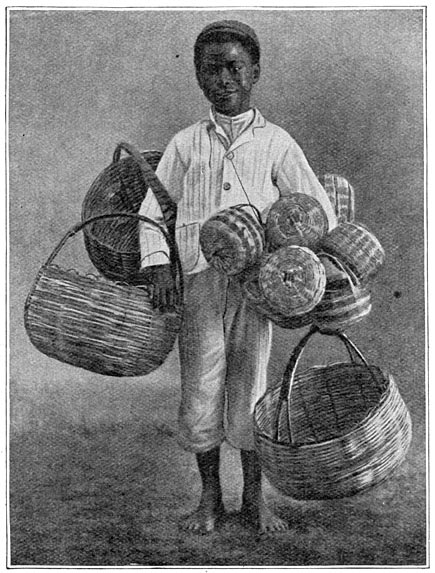 Een negerjongen te Barbados die mandjes te koop biedt.
