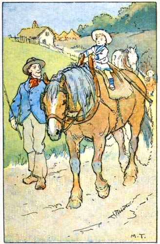 A man leading a draft horse with a small child perched on top