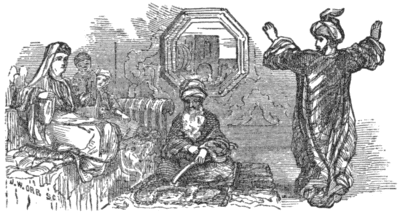 A seated woman watches a man standing with his arms raised. An older man sits
on the floor between them