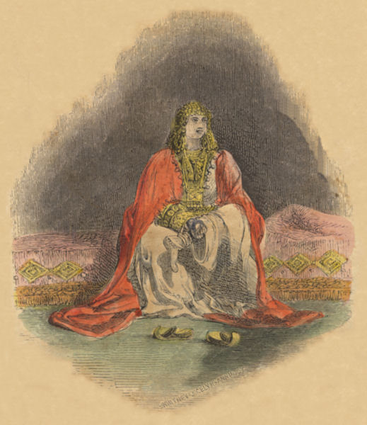 An elaborately robed woman, wearing much gold, sits on a gold-embellished divan