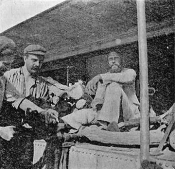 Neufeld on Gunboat "Sheik"—Cutting off his
Ankle-Irons.