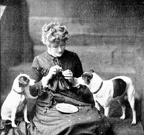 Ellen Terry feeding her dogs
