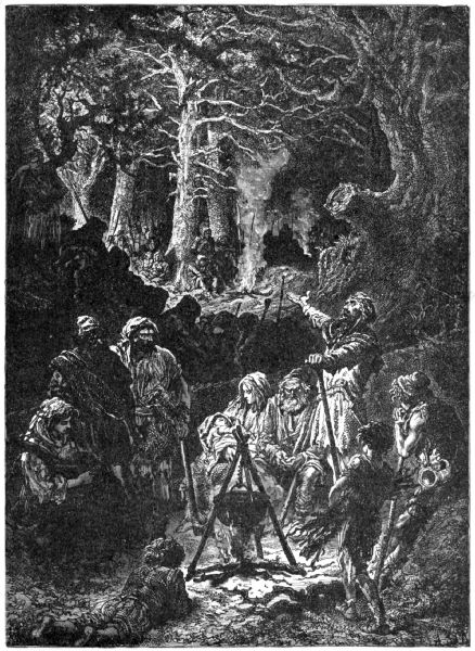 A small group gather round a cauldron in the woods