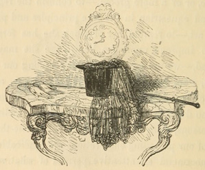 Top hat with veil and a whip on a table