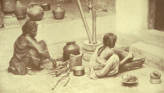 Cooking in a house of the Shanar Caste, always the most accessible of all Castes here, but this is a specially friendly house, or we should not have been allowed to take the photo. The small girl who is grinding curry stuff on the stone is the "Imp" of chapter xx.