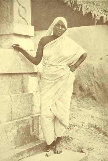 A Brahman widow, the only Brahman woman who would let us take her photo. Brahman women wear their seeleys fastened in a peculiar way, and never cut their ears. Brahman widows are always shaven, and wear no jewels. This one is a muscular character, strong and resolute, an ordinary looking woman, but there must be an under-the-surface life which does not show. A widow's fate is described in one word here, "accursed."