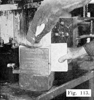 Fig. 113 Inserting Plate Press Boards Between Negatives Preparatory to Pressing