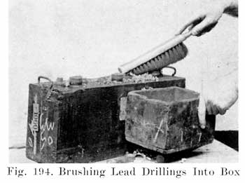 Fig. 194 Brushing lead drillings into box