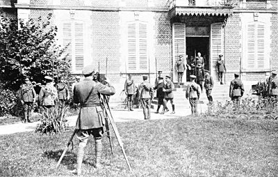 FILMING THE KING DURING HIS VISIT TO FRANCE IN 1916. HE IS ACCOMPANIED BY PRESIDENT POINCARÉ,
SIR DOUGLAS HAIG, GENERAL JOFFRE AND GENERAL FOCH