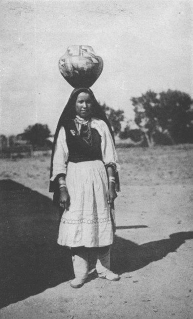 An Indian girl of Isleta, New Mexico, carrying a water
jar.