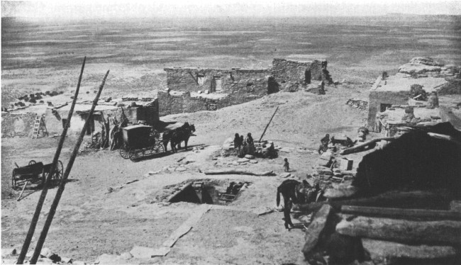 On top of the world—a Moki city on a Mesa in the Painted
Desert. At the left are the ends of a ladder leading from an underground
council chamber
