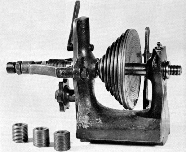 Figure 16.—Headstock of a German instrument-maker’s
lathe, typical of the mid-19th century, showing the traverse spindle,
interchangeable lead screws, and semicircumferential nut containing
several leads. The nut may be brought into engagement by the lever at
top rear of the headstock. This releases the end thrust control on the
spindle simultaneously with engagement of the nut. (Smithsonian photo
49839.)