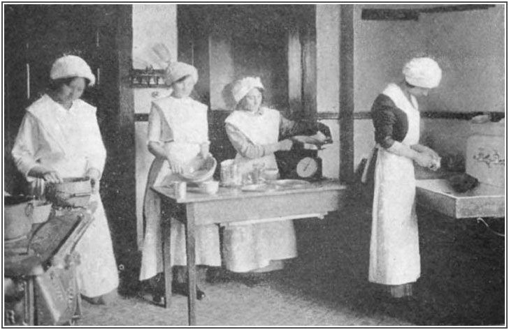 A domestic science class at work in the model school home shown above
