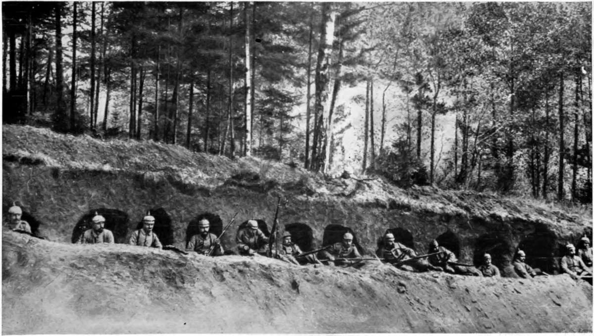 IN SHELTERS SUGGESTING A ROW OF MINIATURE RAILWAY-ARCHES! GERMANS IN THEIR "RABBIT-WARRENS" IN THE ARGONNE.