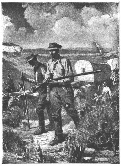 A man carries a rifle. He is on a broad plain, surrounded by wagons and people.