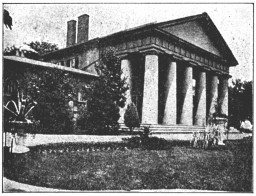 A photograph of a colonnaded mansion.