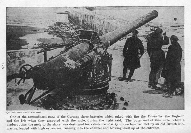 One of the camouflaged guns of the German shore batteries which raked with fire the Vindictive, the Daffodil, and the Iris when they grappled with the mole, during the night raid. The outer end of this mole, where a viaduct joins the mole to the shore, was destroyed for a distance of sixty to one hundred feet by an old British submarine, loaded with high explosives, running into the channel and blowing itself up at the entrance.