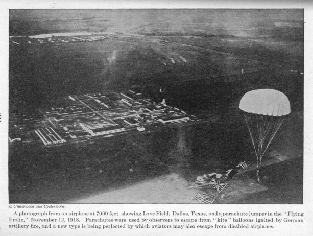 A photograph from an airplane at 7900 feet, showing Love Field, Dallas, Texas, and a parachute jumper in the "Flying Frolic," November 12, 1918.  Parachutes were used by observers to escape from "kite" balloons ignited by German artillery fire, and a new type is being perfected by which aviators may also escape from disabled airplanes.