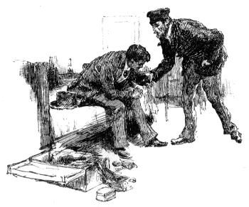 A seated man leans over his knees, while another man confronts him.