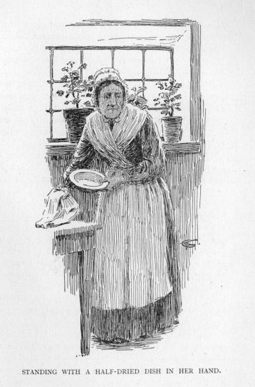 Standing with a half-dried dish in her hand.