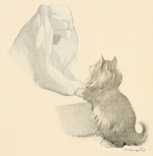 A kitten touches its front paws to the paws of a stone lion