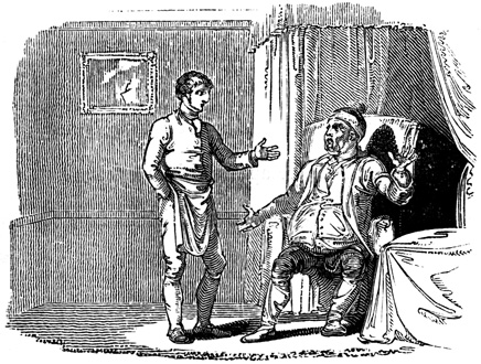 A man in an apron speaks with a seated, angry loooking man.
