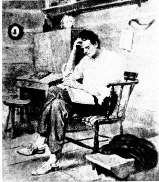 Lincoln sitting in a chair, reading a book