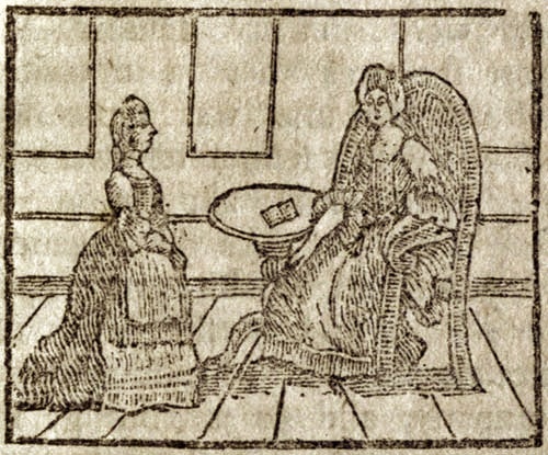 Two women, one standing and one seated