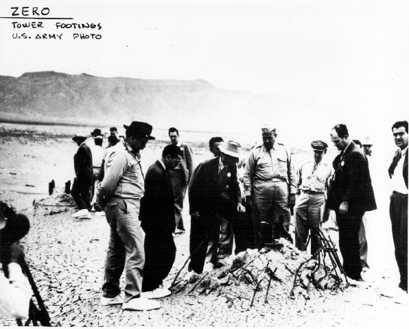 Oppenheimer and Groves examine tower piling in crater