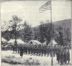 SALUTING THE FLAG IN A GIRL SCOUT CAMP
