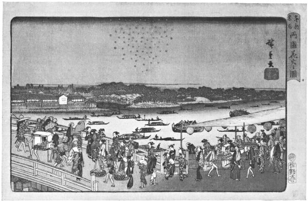 A large crowd watches fireworks bursting over the river