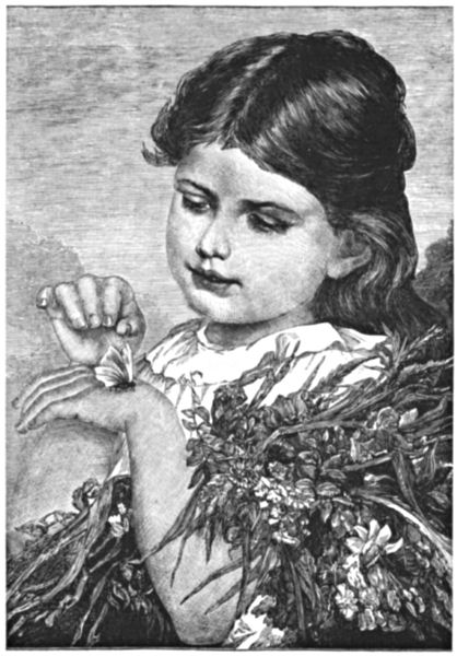 A little girl with an armful of flowers examines a butterfly perched on her hand