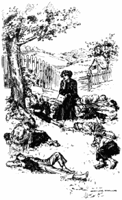 Miss Cecilia Loring is sitting down with a closed book in her left hand and holding up her right hand to her chin as she's thinking. There are nine boys sprawled around her on the ground in varying positions, sleeping. In the background there is a fence with an open gate beyond which a small house and a large tree in front of it can be seen.