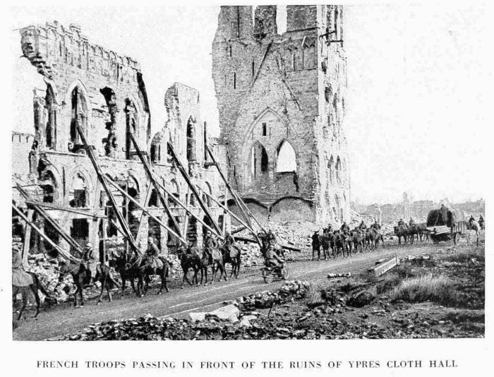 FRENCH TROOPS PASSING IN FRONT OF THE RUINS OF YPRES CLOTH HALL