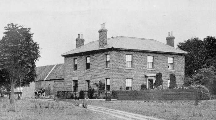 Exterior view of a substantial brick countryside manor with
three fireplaces.